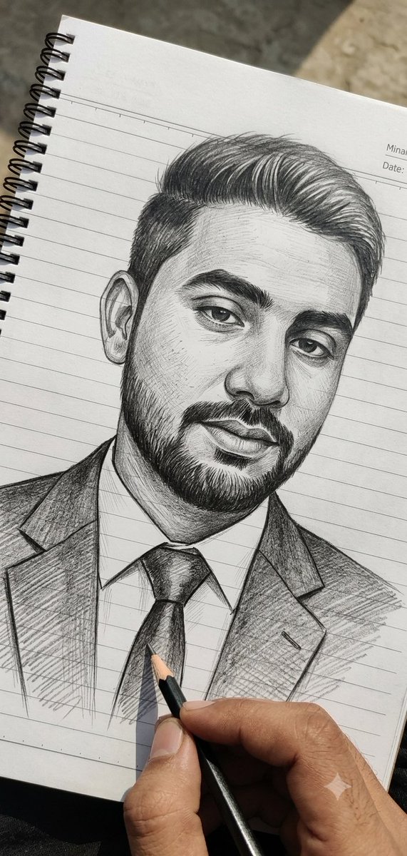 Pencil Sketch Portrait Being Drawn By Hand on a White Spiral-bound Notebook with Horizontal Blue
